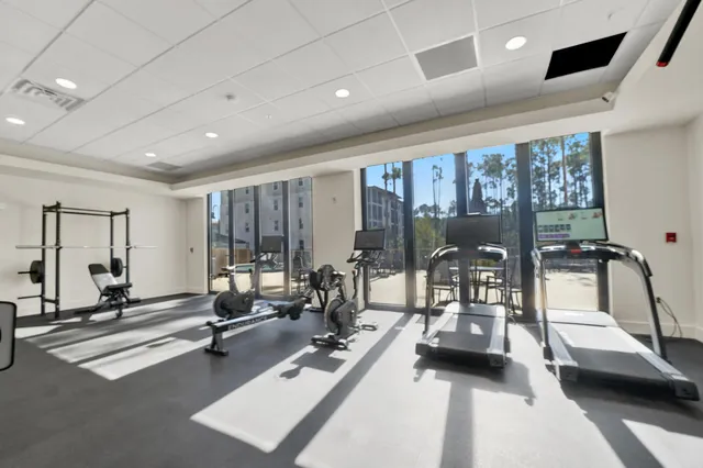 a room with gym equipment and floor to ceiling window