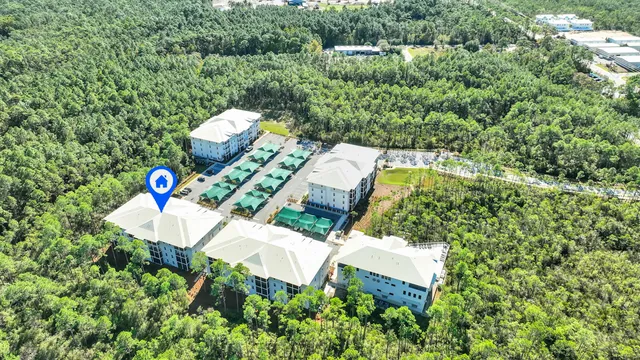 a view of a swimming pool with a yard and potted plants