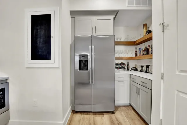 a kitchen with cabinets and stainless steel appliances