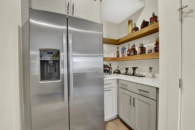 a kitchen with stainless steel appliances cabinets and a refrigerator