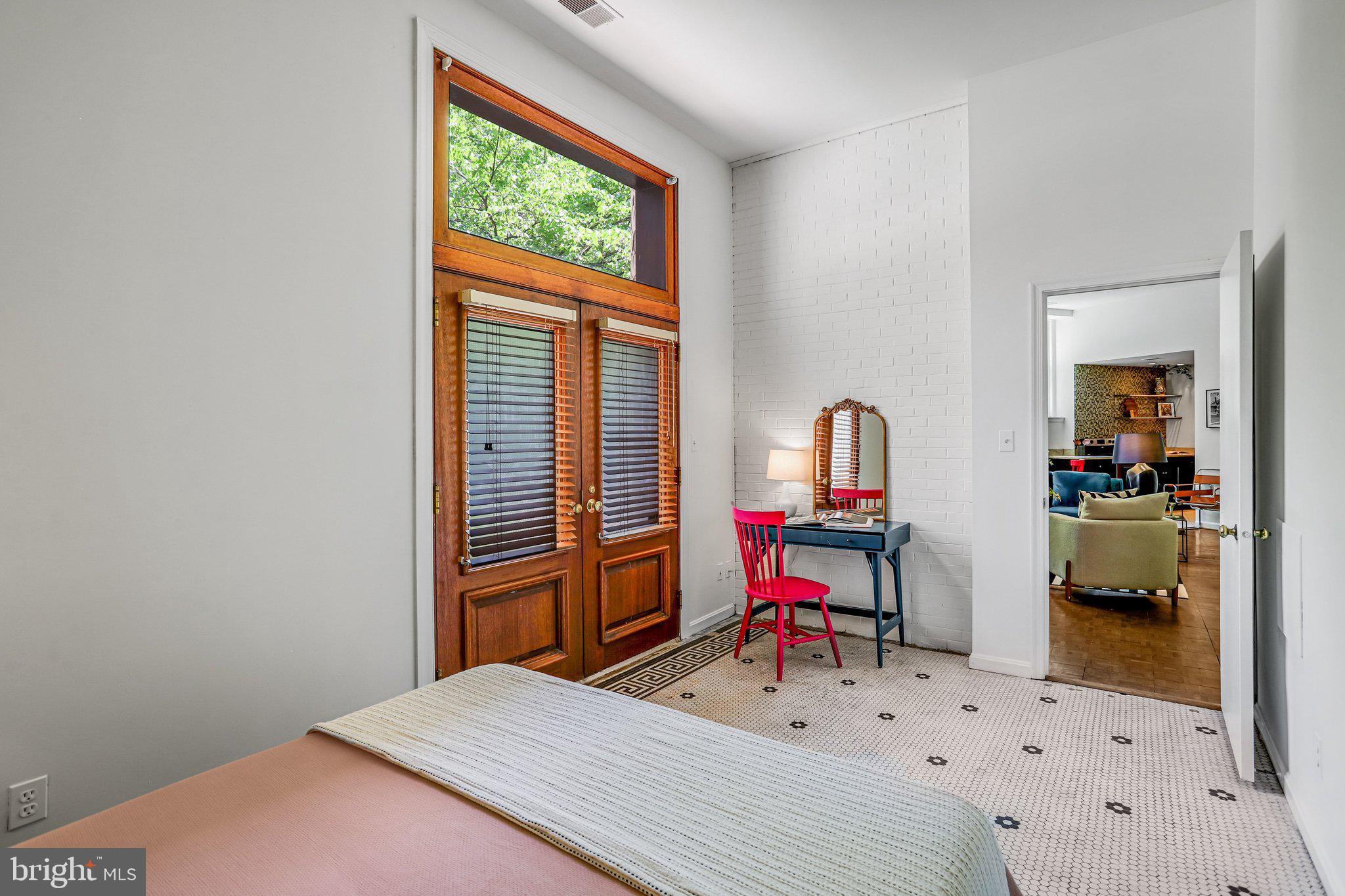 2001 16th Street Northwest, Unit 105 Washington, DC 20009 - Photo 7 of 16 a bedroom with a bed and a table in it