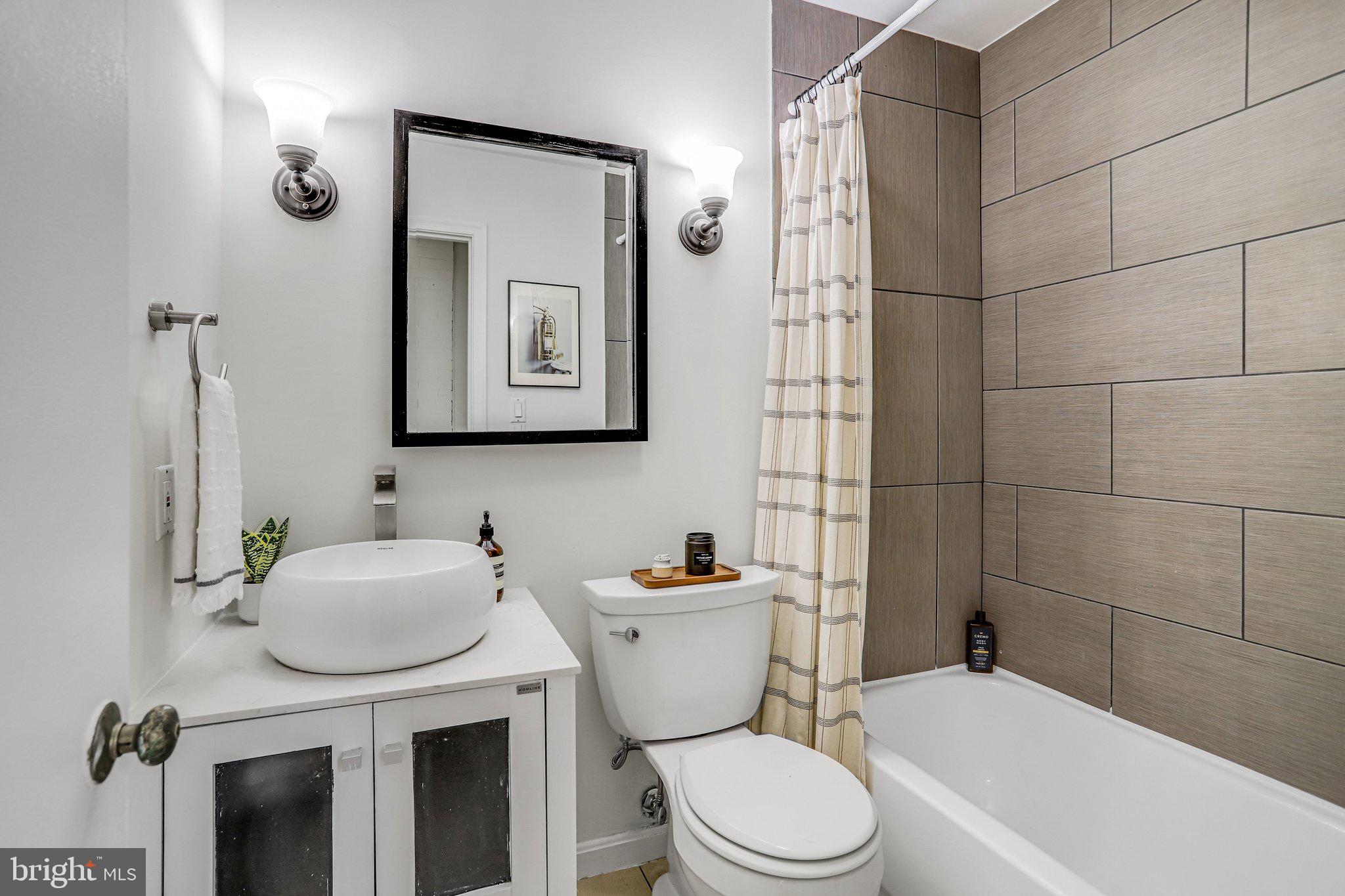 2001 16th Street Northwest, Unit 105 Washington, DC 20009 - Photo 8 of 16 a bathroom with a toilet sink and mirror