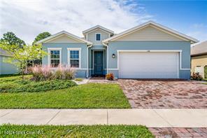 Undisclosed Address Vero Beach, FL 32967 - Photo 2 of 36 a front view of a house with a yard and garage