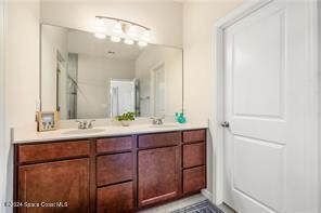Undisclosed Address Vero Beach, FL 32967 - Photo 22 of 36 a bathroom with a double vanity sink and a mirror