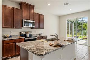 Undisclosed Address Vero Beach, FL 32967 - Photo 3 of 36 a kitchen with stainless steel appliances granite countertop a sink and a stove