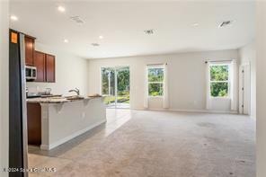 Undisclosed Address Vero Beach, FL 32967 - Photo 6 of 36 a large white kitchen with granite countertop a large window and a sink