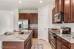 Undisclosed Address Vero Beach, FL 32967 - Photo 9 of 36 a kitchen with stainless steel appliances granite countertop a sink stove and cabinets