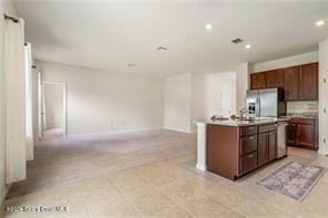 Undisclosed Address Vero Beach, FL 32967 - Photo 10 of 36 a kitchen with stainless steel appliances granite countertop a stove a sink and a refrigerator with white cabinets