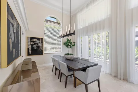 a living room with furniture a flat screen tv and a large window