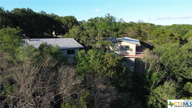 a view of a house with a yard and tree s