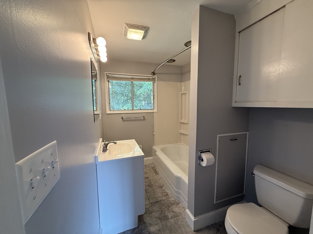 36 5th Avenue Lowell, MA 01854 - Photo 12 of 16 a bathroom with a toilet sink and mirror