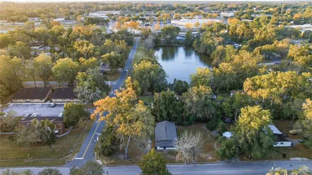 an aerial view of residential houses with outdoor space and swimming pool