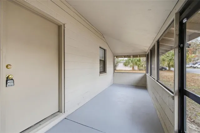 a view of a big room with wooden floor and windows