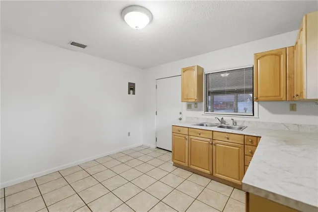 a spacious bathroom with a granite countertop sink and a mirror