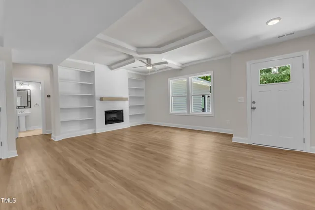 wooden floor in an empty room with a fireplace