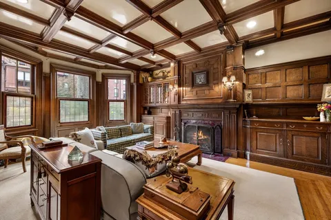 a living room with furniture fireplace and flat screen tv