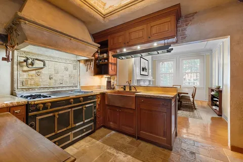 a kitchen with wooden cabinets and a stove top oven