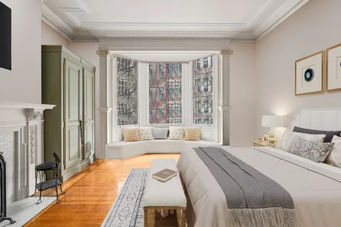 a bedroom with a large bed and a large window