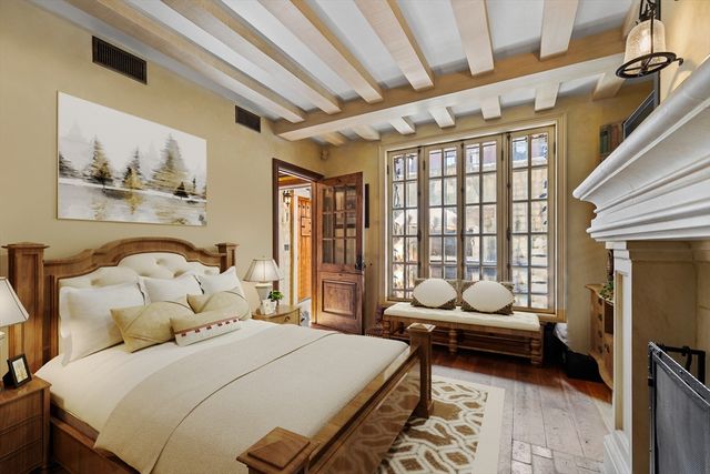 a bedroom with a bed couch and window