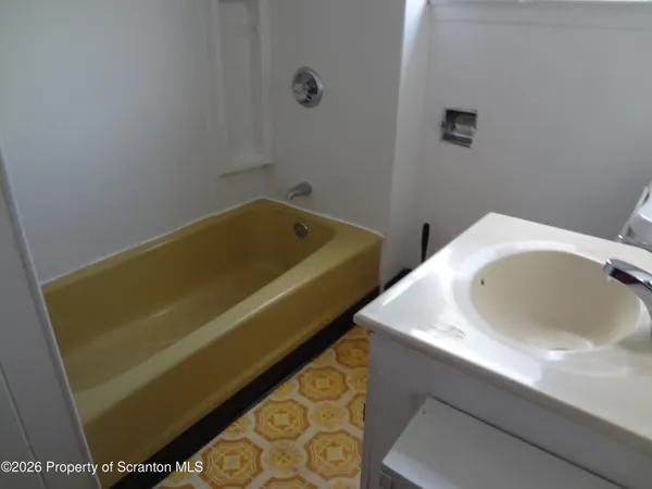 a bathroom with a sink toilet and tub