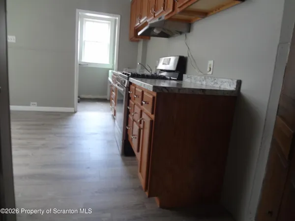 a kitchen with stainless steel appliances granite countertop a refrigerator stove and sink