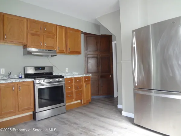a kitchen with granite countertop a stove a microwave and cabinets