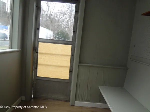 a view of a yard with wooden fence