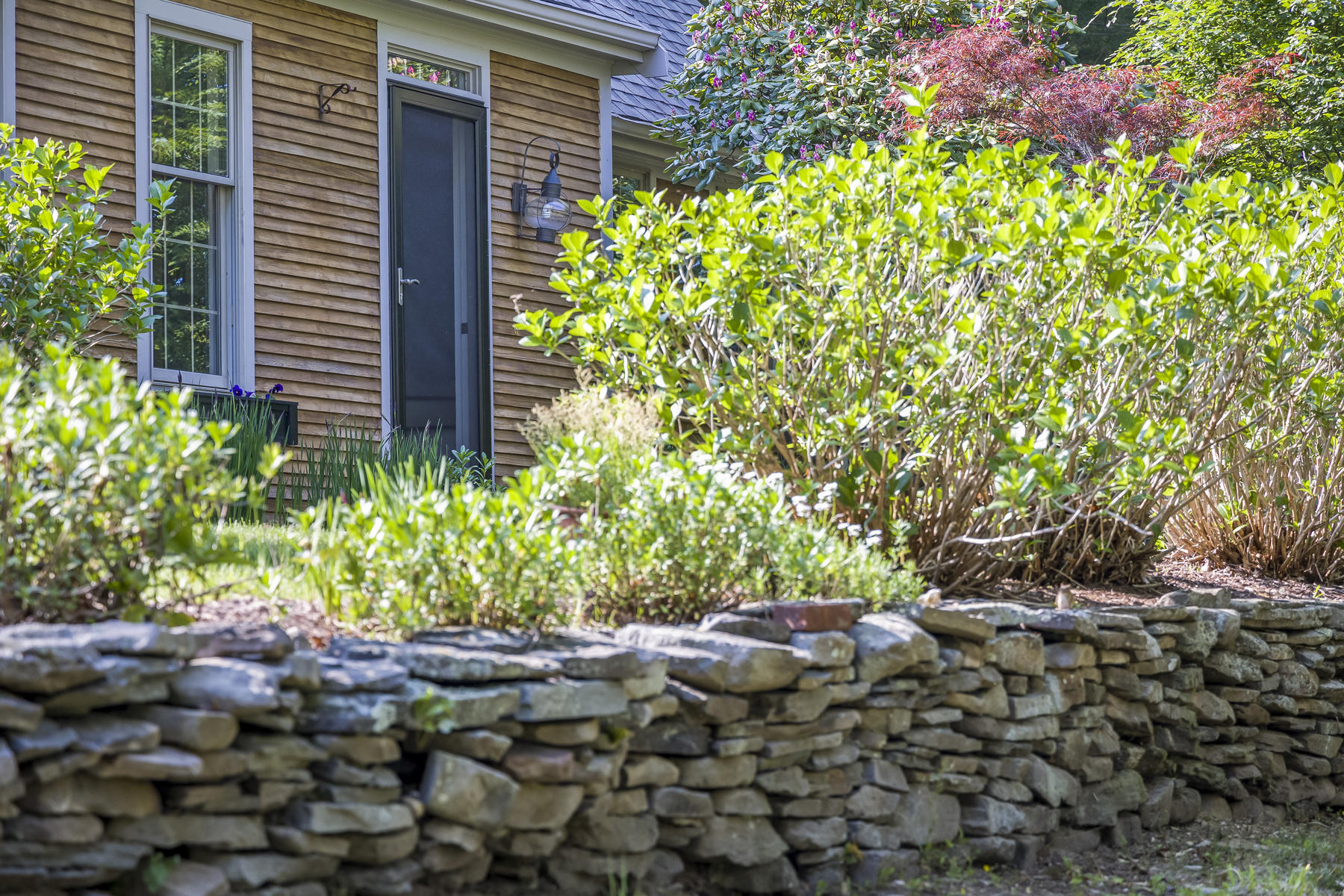 2 Greengate Road Falmouth, MA 02540 - Photo 44 of 51 a couple of table and a flowers in front of a house