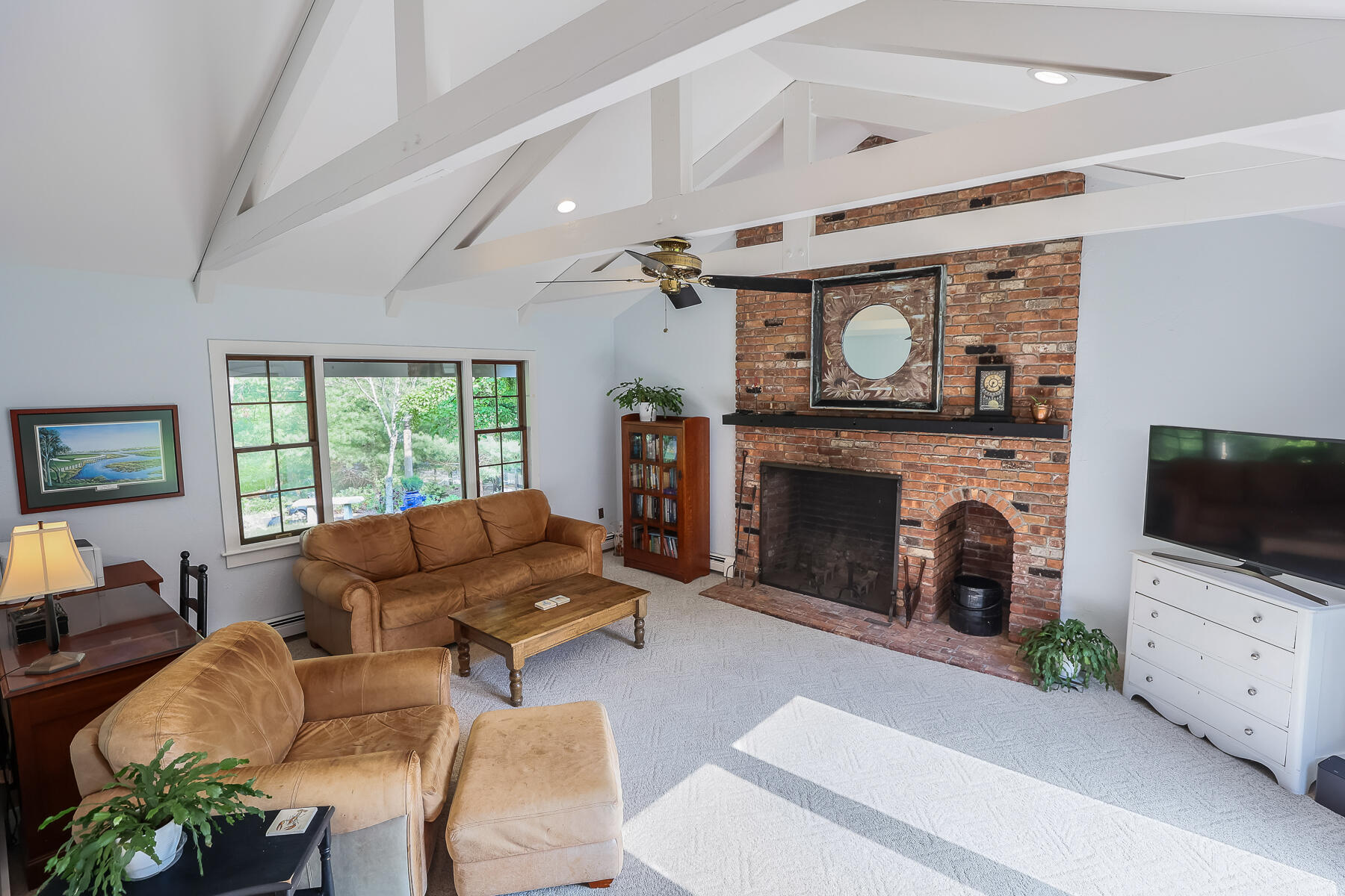 2 Greengate Road Falmouth, MA 02540 - Photo 8 of 51 a living room with furniture a flat screen tv and a fireplace