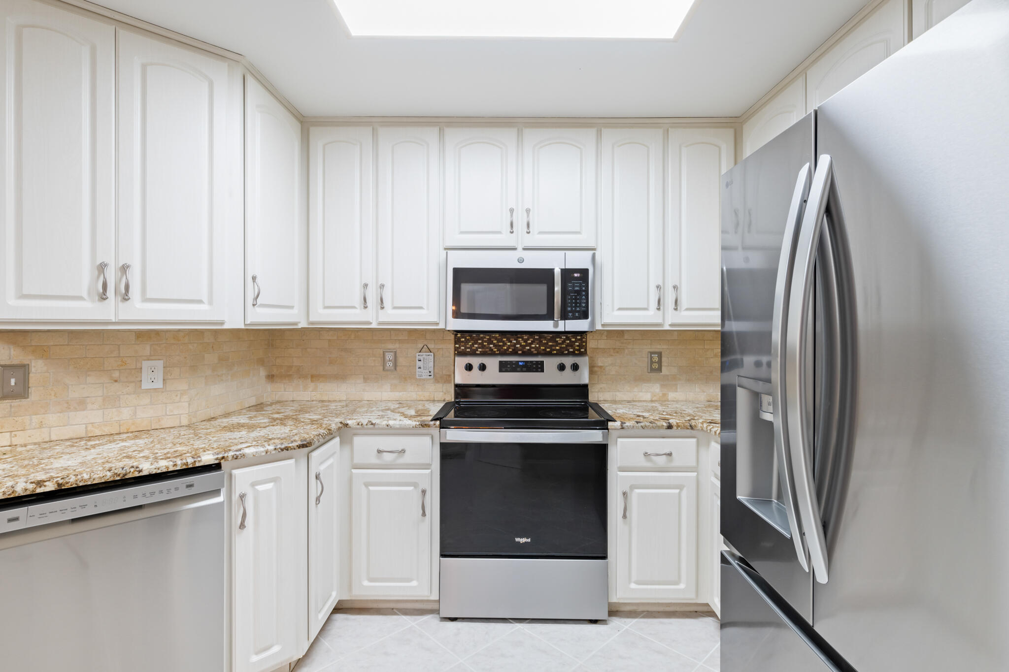 2567 Valley Road Navarre, FL 32566 - Photo 14 of 60 a kitchen with a stove microwave and refrigerator