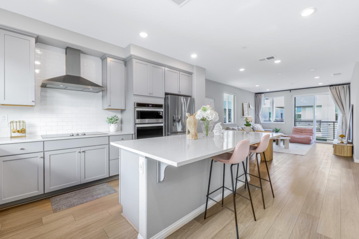 2510 Fruit Ranch Loop San Jose, CA 95133 - Photo 1 of 1 a kitchen with stainless steel appliances kitchen island granite countertop a table chairs sink and cabinets