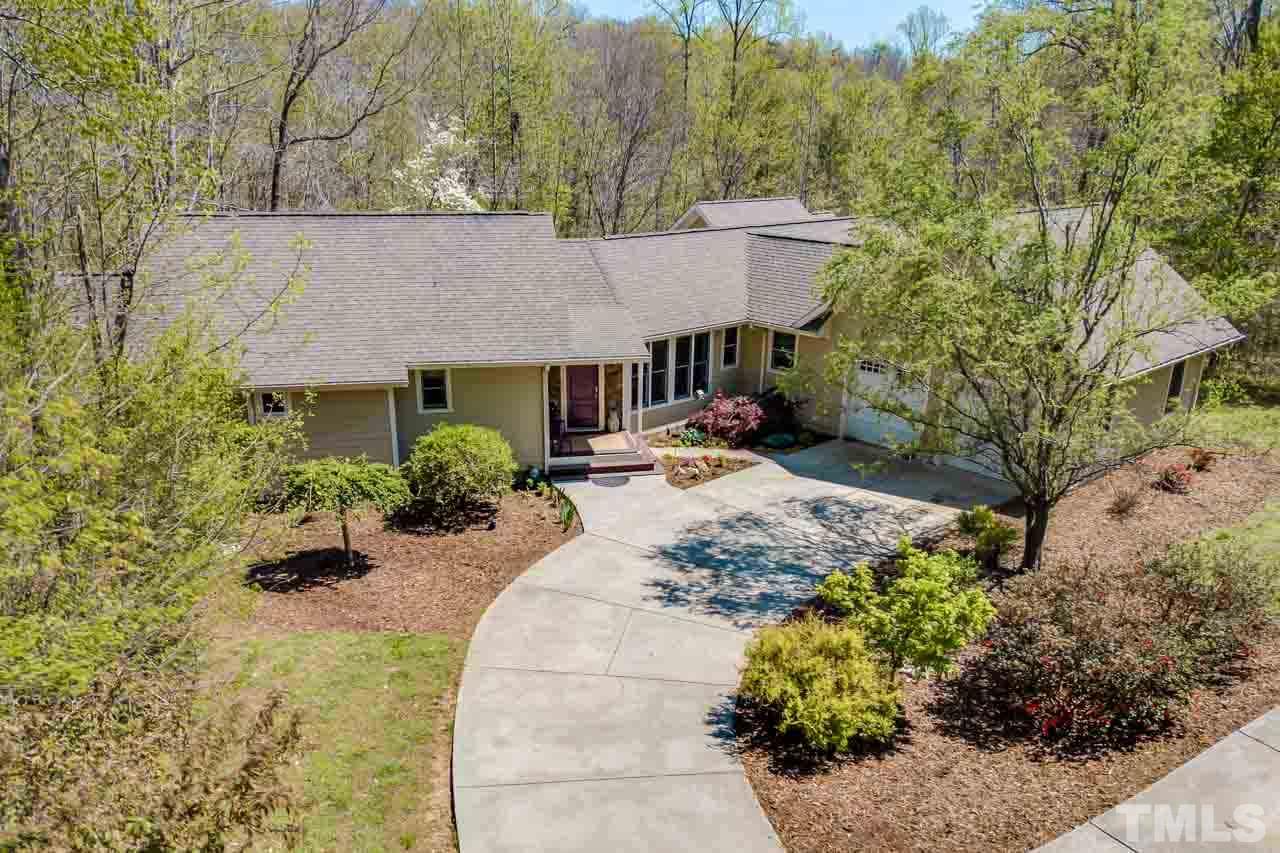 402 Bowen Road Rougemont, NC 27572 - Photo 1 of 25 a view of a house with a small yard and large trees