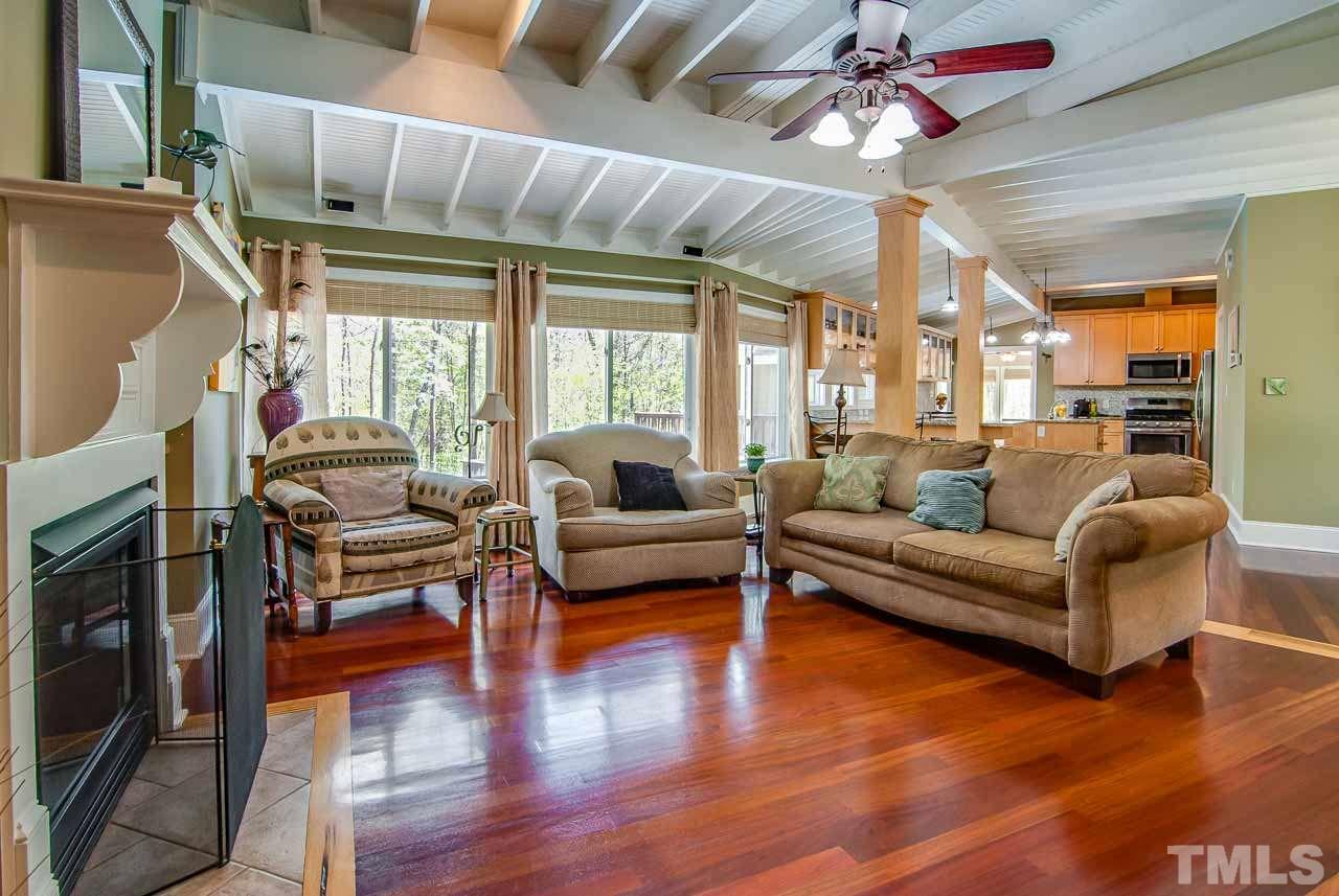 402 Bowen Road Rougemont, NC 27572 - Photo 2 of 25 a living room with furniture a ceiling fan a fireplace and a large window