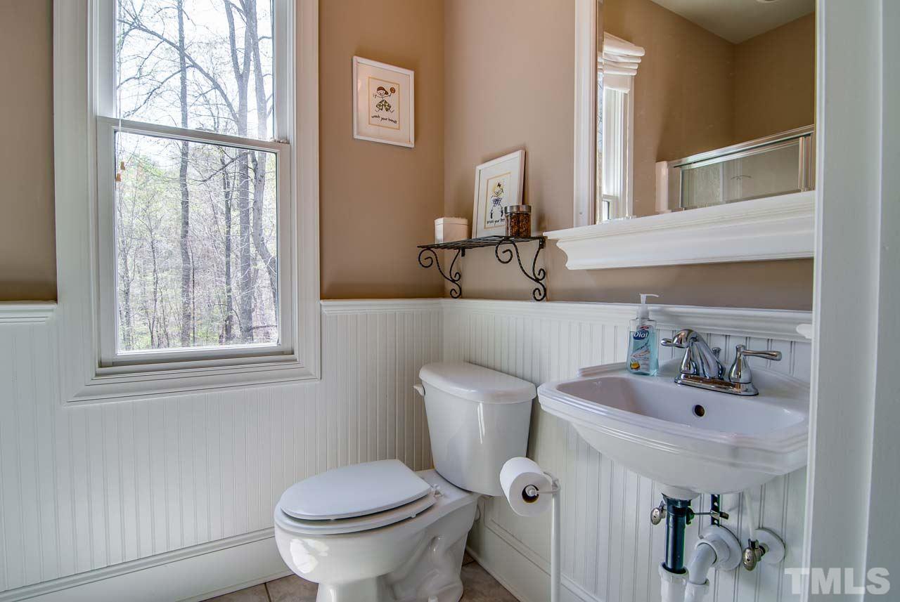402 Bowen Road Rougemont, NC 27572 - Photo 15 of 25 a bathroom with a toilet sink and mirror
