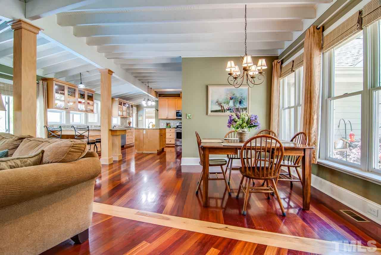 402 Bowen Road Rougemont, NC 27572 - Photo 3 of 25 a view of a dining room and livingroom with furniture wooden floor a chandelier