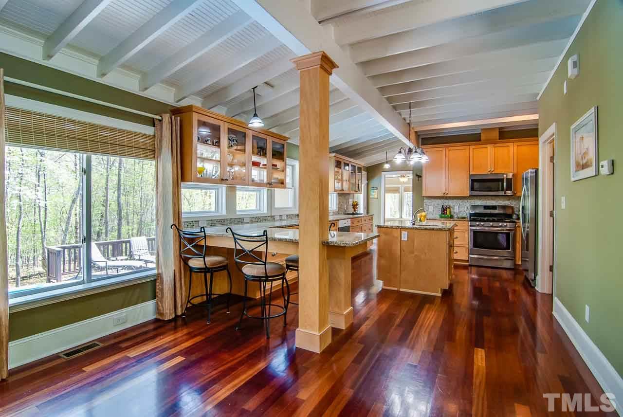 402 Bowen Road Rougemont, NC 27572 - Photo 7 of 25 a kitchen with wooden floors and wooden cabinets