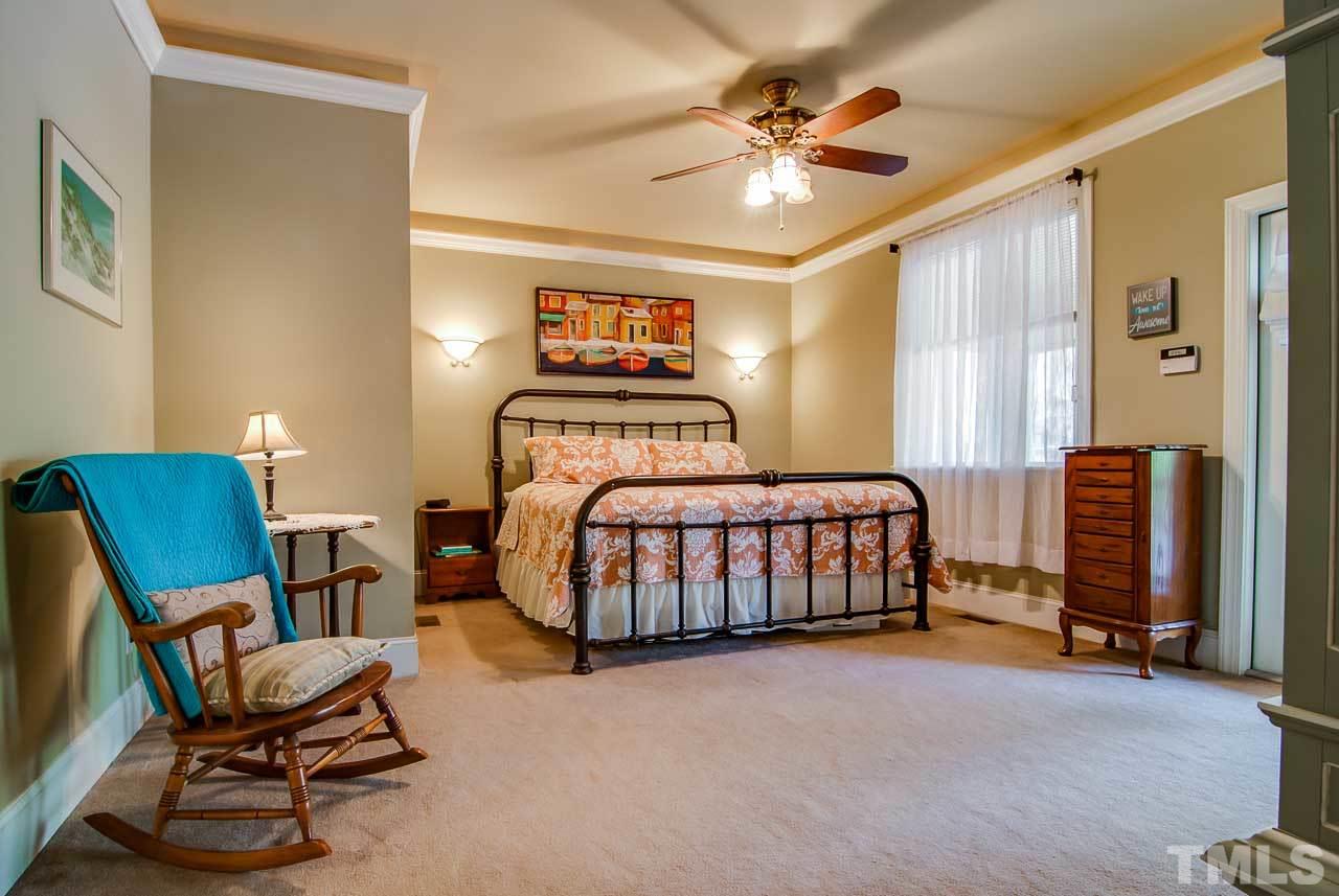 402 Bowen Road Rougemont, NC 27572 - Photo 10 of 25 a bedroom with a bed and a chair in it