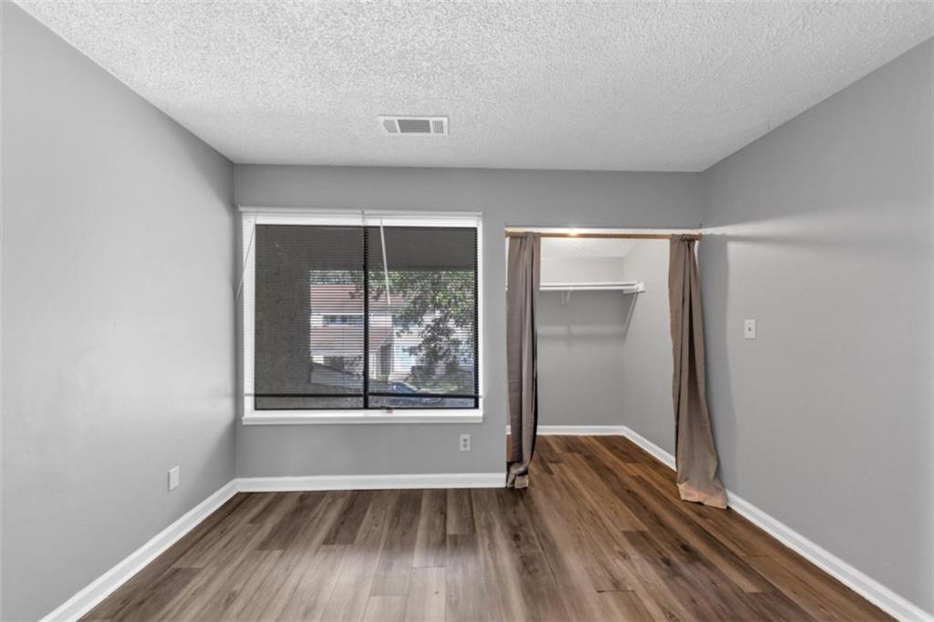 3575 Oakvale Road, Unit 504 Decatur, GA 30034 - Photo 10 of 13 an empty room with wooden floor and windows