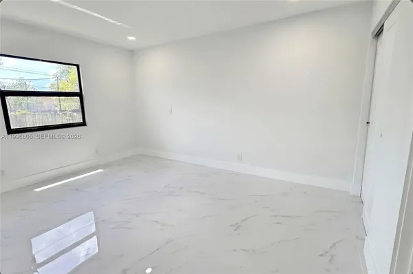 a view of wooden floor and trees in the background