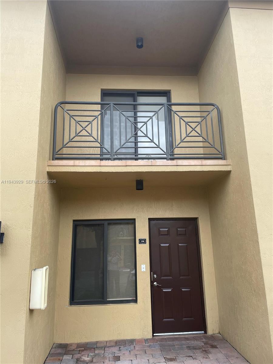 11115 West Okeechobee Road, Unit 154 Hialeah Gardens, FL 33018 - Photo 11 of 30 a front view of a house with a garage