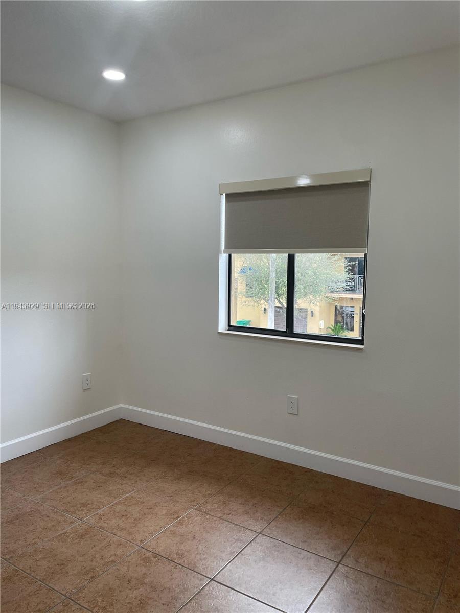 11115 West Okeechobee Road, Unit 154 Hialeah Gardens, FL 33018 - Photo 14 of 30 an empty room with a window