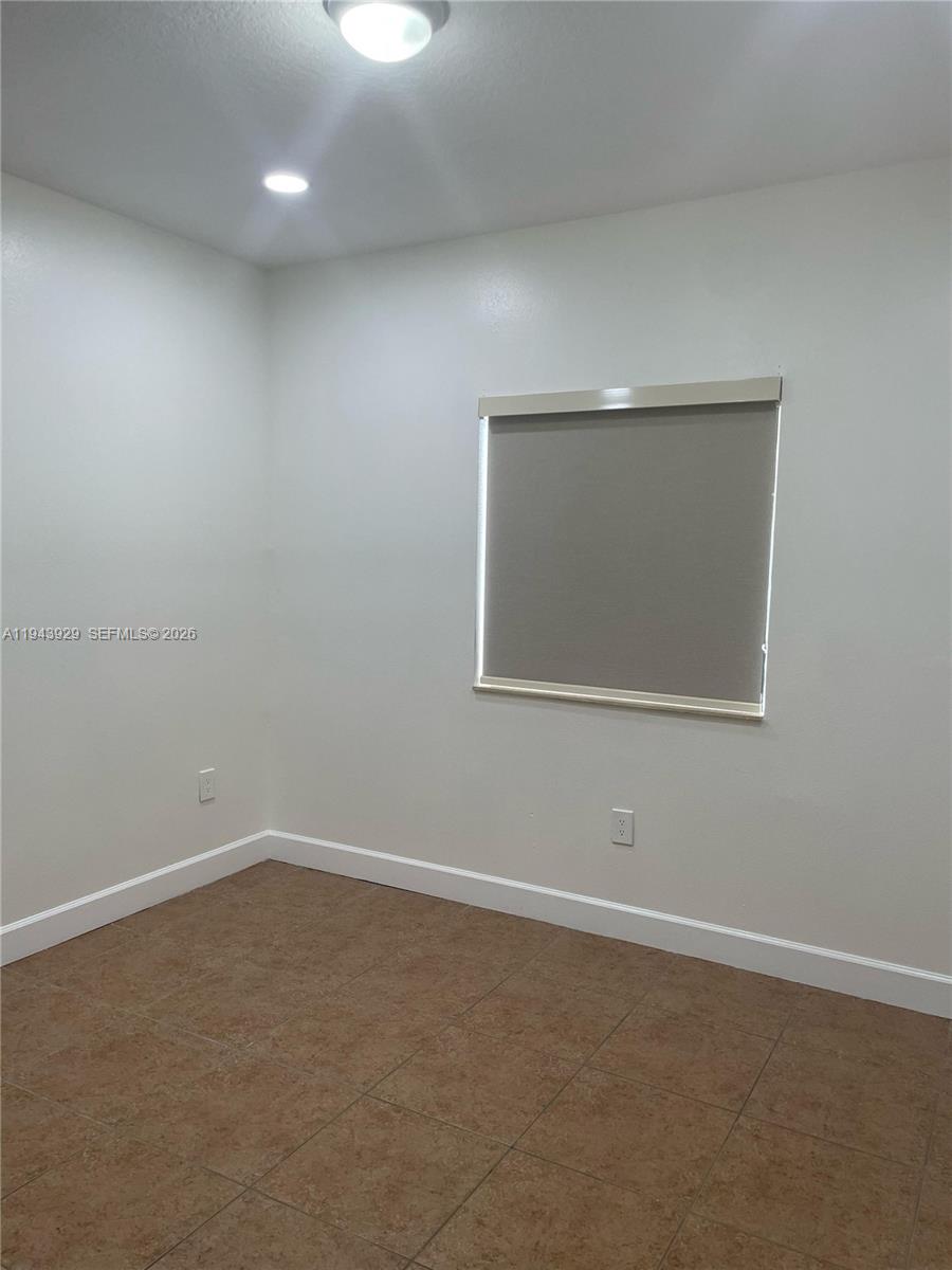 11115 West Okeechobee Road, Unit 154 Hialeah Gardens, FL 33018 - Photo 16 of 30 an empty room with a window