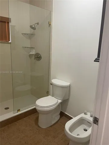 a white toilet sitting next to a bathroom sink