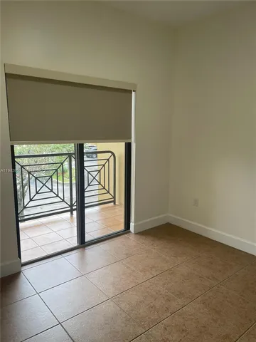 a view of an empty room and wooden floor