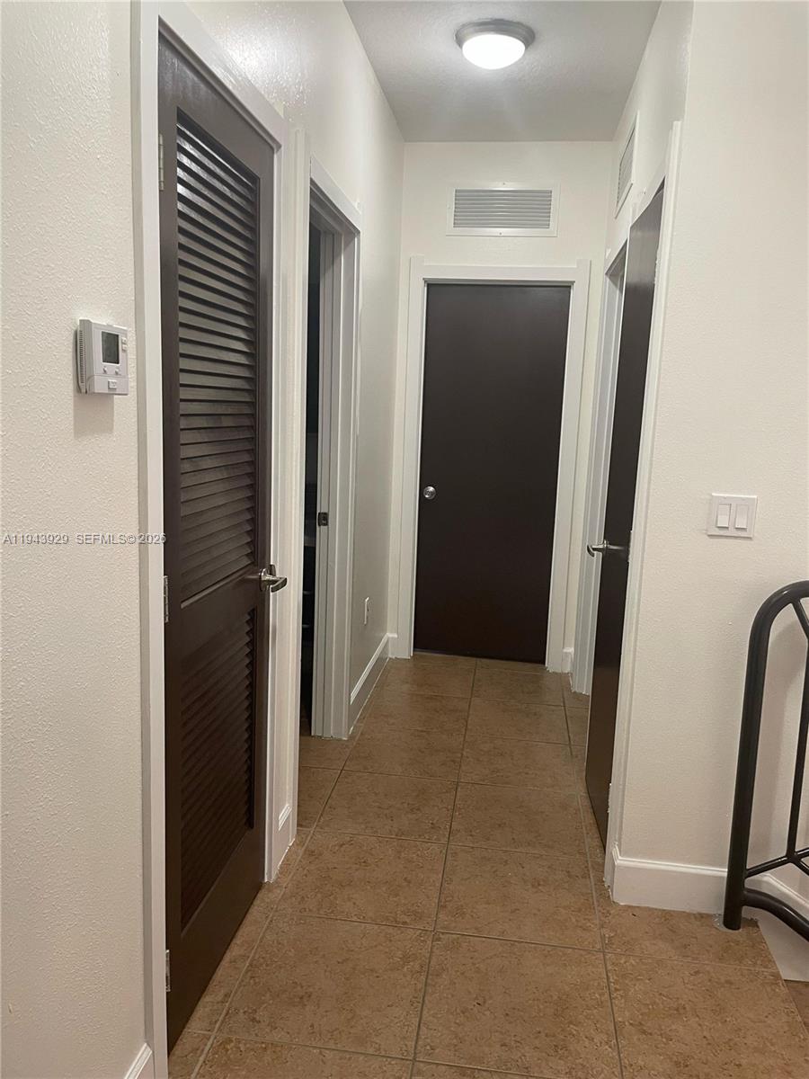 11115 West Okeechobee Road, Unit 154 Hialeah Gardens, FL 33018 - Photo 22 of 30 a view of a hallway to rooms and stairs