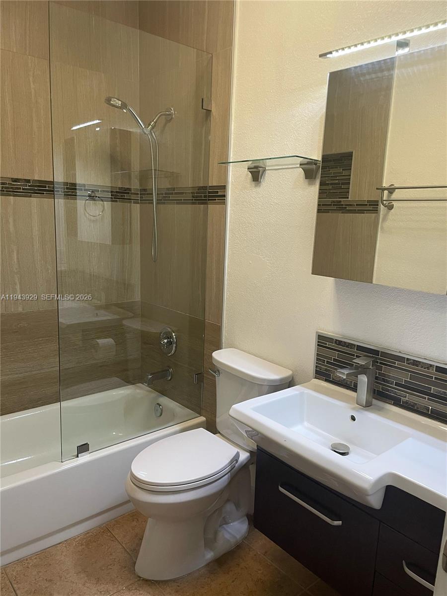 11115 West Okeechobee Road, Unit 154 Hialeah Gardens, FL 33018 - Photo 23 of 30 a bathroom with a sink a toilet and shower
