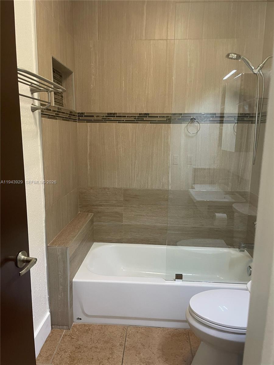 11115 West Okeechobee Road, Unit 154 Hialeah Gardens, FL 33018 - Photo 26 of 30 a bathroom with a bathtub and a shower
