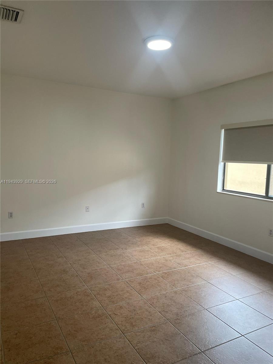 11115 West Okeechobee Road, Unit 154 Hialeah Gardens, FL 33018 - Photo 3 of 30 an empty room with a empty space and window