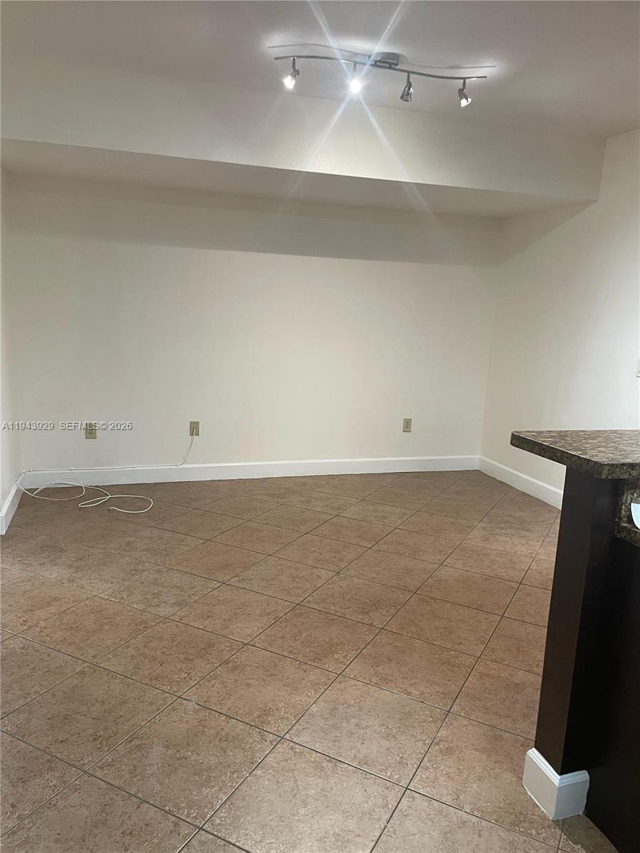 11115 West Okeechobee Road, Unit 154 Hialeah Gardens, FL 33018 - Photo 4 of 30 an empty room with white walls and tiles