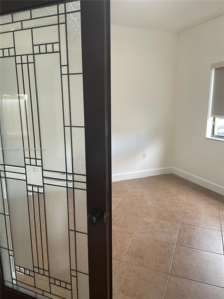 11115 West Okeechobee Road, Unit 154 Hialeah Gardens, FL 33018 - Photo 6 of 30 an empty room with windows